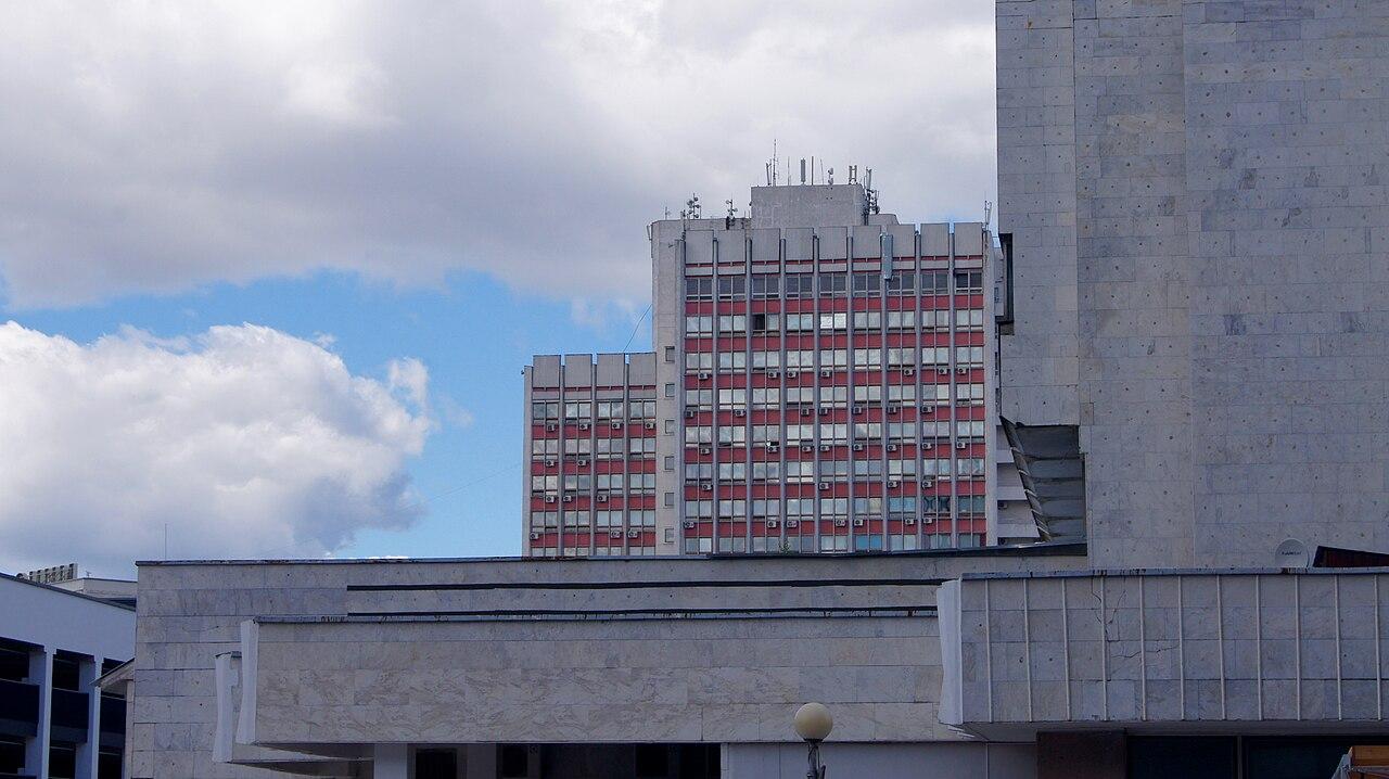 Minsk National Airport terminal exterior with Cyrillic signage and departures roadway