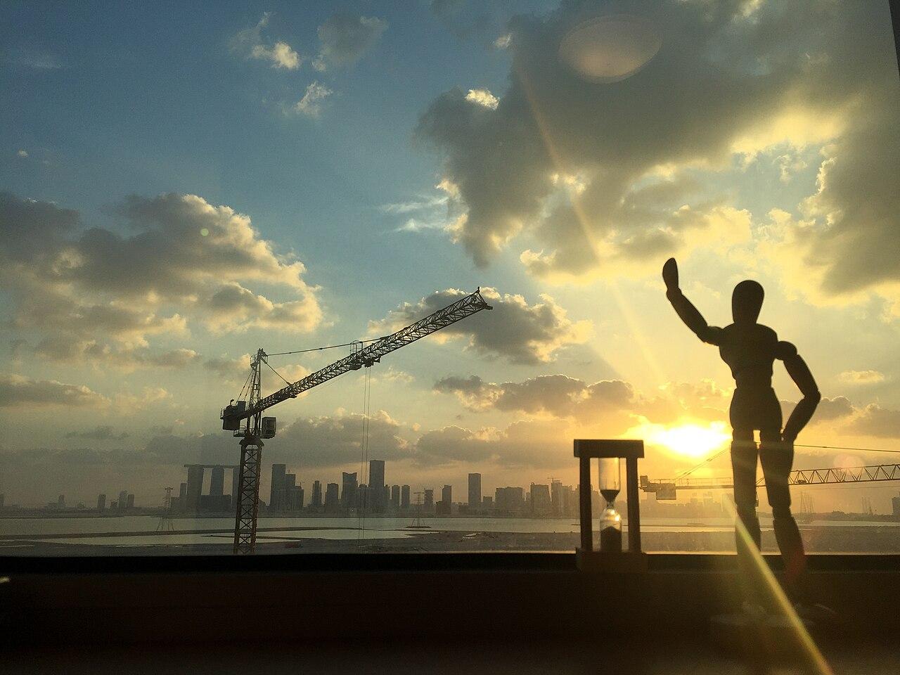 Abu Dhabi International Airport terminal view at sunset with city skyline