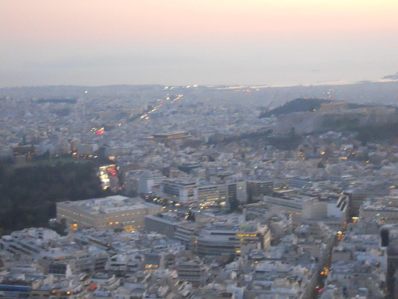 Aerial dusk view over Athens city with the Acropolis visible in the distance