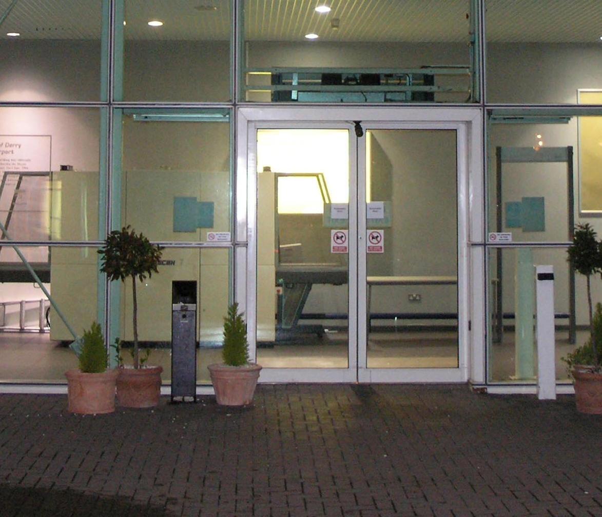 City of Derry Airport main terminal entrance at night with ashtray outside doors
