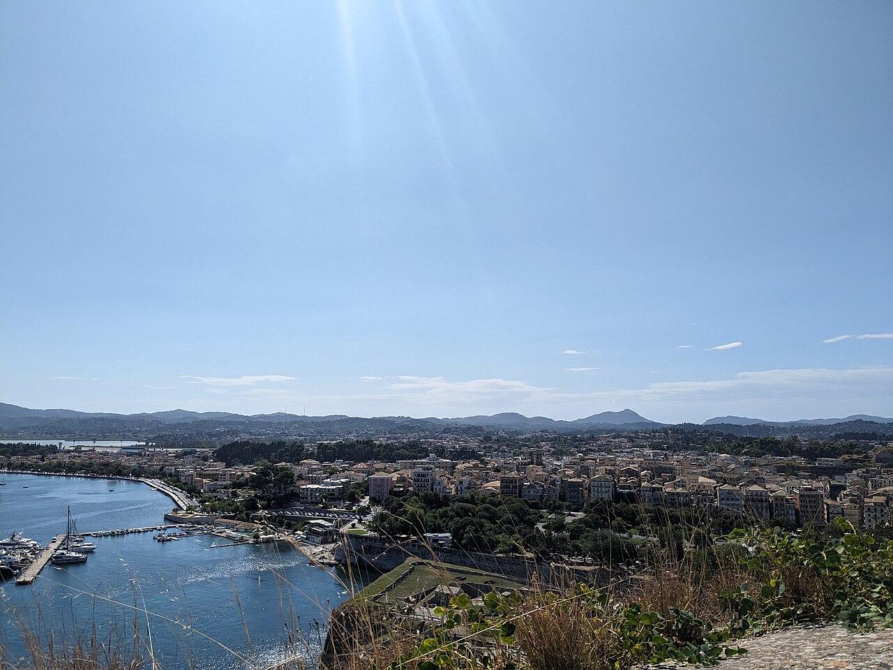 Collage showing Corfu Airport travel scenes including a Ryanair plane and the Corfu fortress