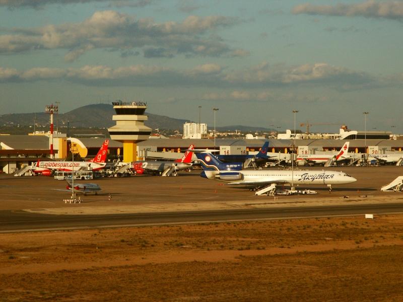 Faro Airport apron at golden hour with multiple aircraft and control tower