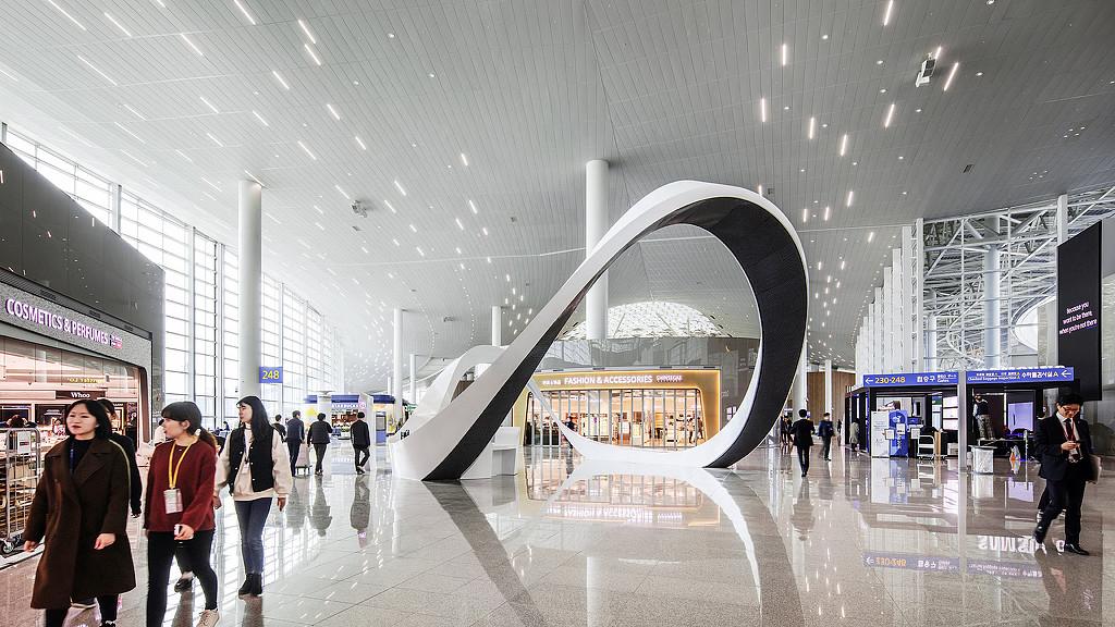 Incheon International Airport Terminal 2 interior with large sculpture and duty-free shops