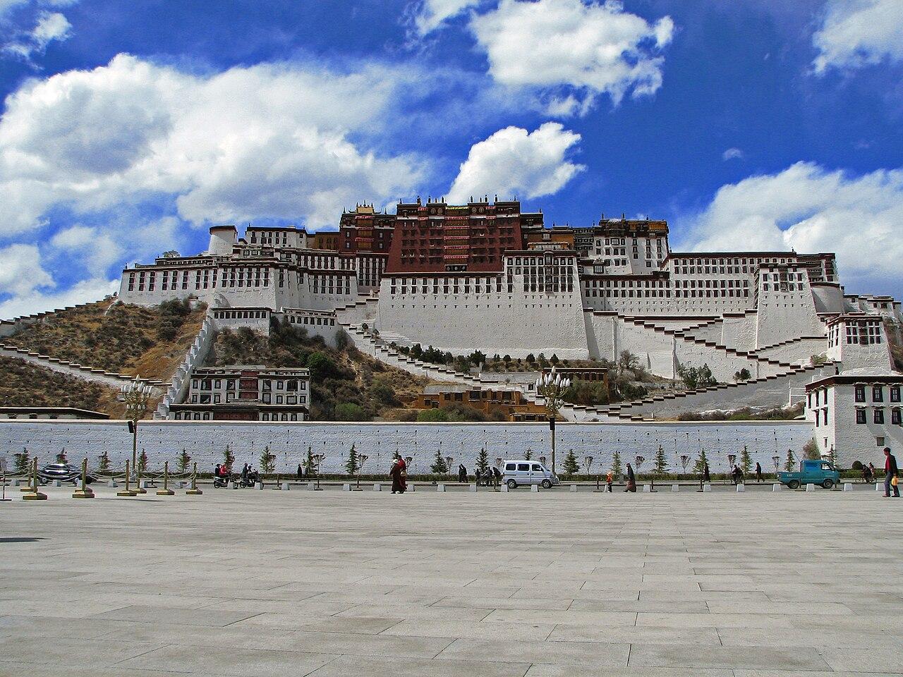 Lhasa Gonggar Airport apron with aircraft and snow-capped Himalayan peaks behind