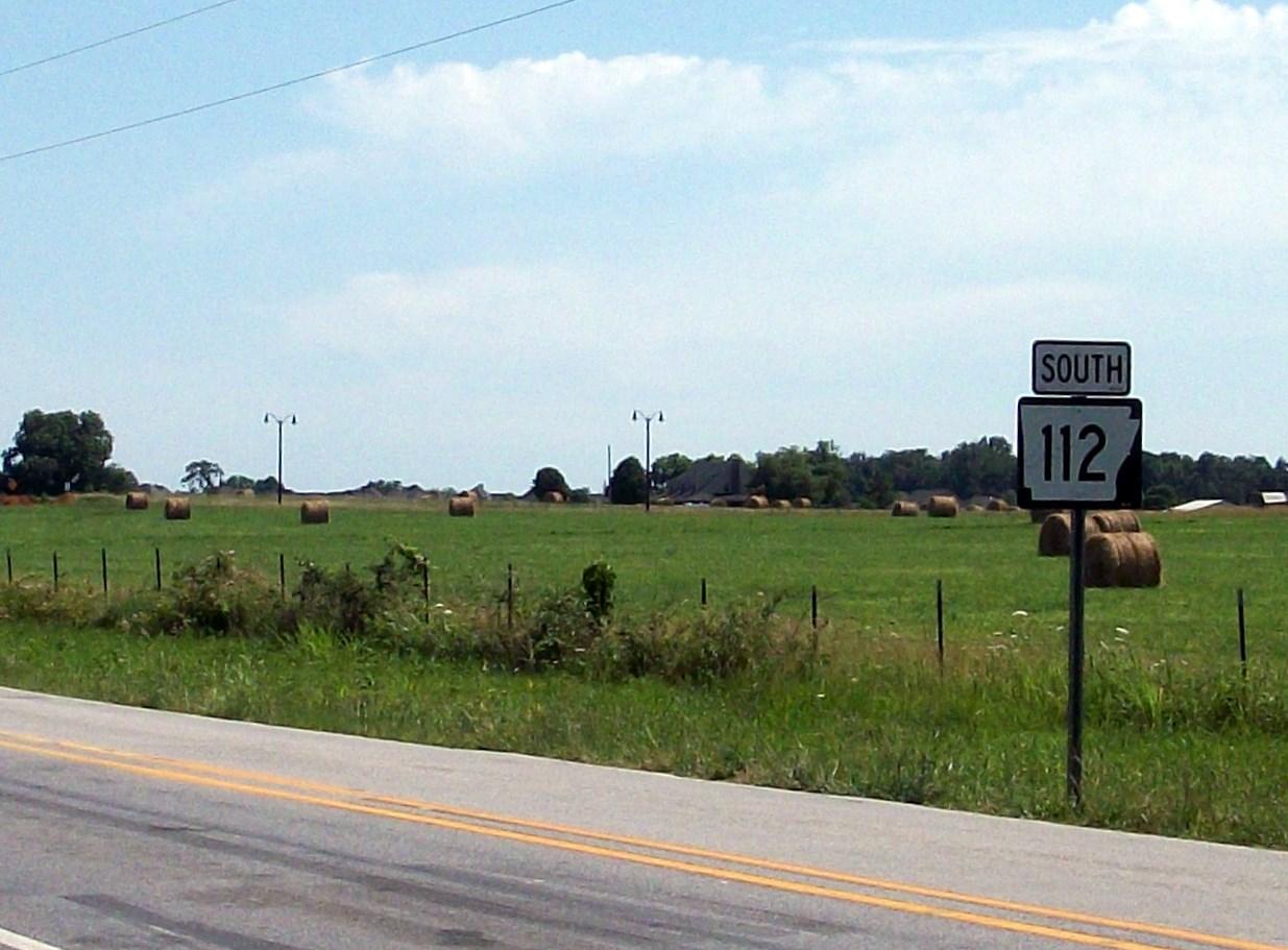 Red pin marking Arkansas on a road map highlighting XNA airport region