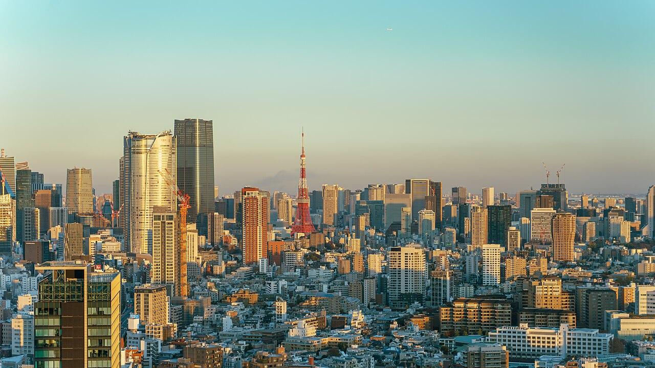 Tokyo cityscape at dusk with Tokyo Tower visible among skyscrapers